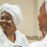 Woman applying moisturizer as part of her anti-aging skincare routine